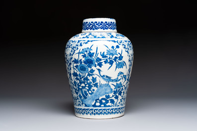 A refined blue and white Dutch Delft jar and cover with a putto on a rock, late 17th C.