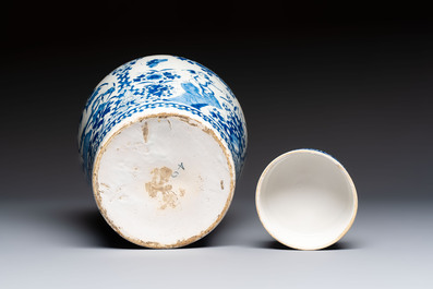 A refined blue and white Dutch Delft jar and cover with a putto on a rock, late 17th C.