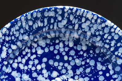 A rare large Nevers white-splashed blue-ground '&agrave; la bougie' dish, France, late 17th C.