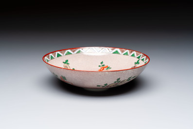 An unusual Chinese famille verte copper-red-ground shallow bowl with floral design, 19th C.