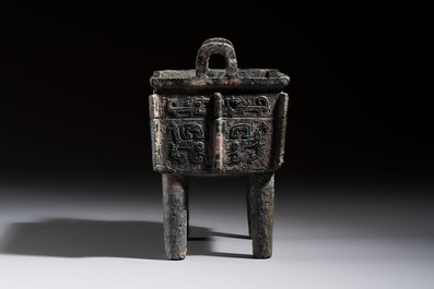 An inscribed Chinese archaic bronze food vessel with Taotie design, Ding 鼎, Western Zhou