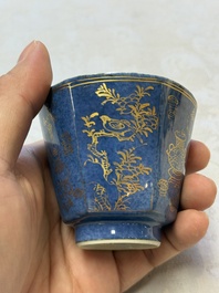 A pair of Chinese gilt-decorated powder-blue-ground 'Antiquities' cups and saucers, lingzhi mark, Kangxi