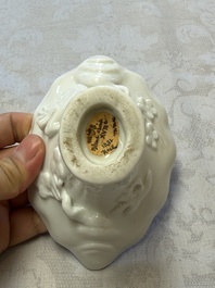 A Chinese Dehua blanc de Chine 'Dragon, Carp, Crane and Deer' libation cup, Kangxi