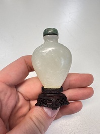 A Chinese carved white jade 'Geese' snuff bottle with a wooden stand, 18/19th C.