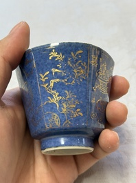A pair of Chinese gilt-decorated powder-blue-ground 'Antiquities' cups and saucers, lingzhi mark, Kangxi