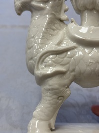 A Chinese Dehua blanc de Chine candlestick in the form a qilin, Kangxi
