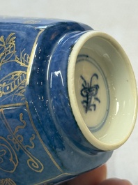 A pair of Chinese gilt-decorated powder-blue-ground 'Antiquities' cups and saucers, lingzhi mark, Kangxi