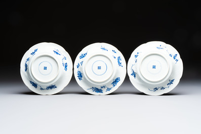 Eleven Chinese blue and white gadrooned 'Flowers and Peacocks' plates, Kangxi