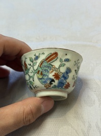 Two Dutch-decorated Chinese cups and saucers with parrots among flowering branches, 18th C.