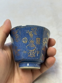 A pair of Chinese gilt-decorated powder-blue-ground 'Antiquities' cups and saucers, lingzhi mark, Kangxi