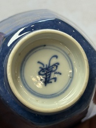 A pair of Chinese gilt-decorated powder-blue-ground 'Antiquities' cups and saucers, lingzhi mark, Kangxi