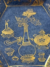 A pair of Chinese gilt-decorated powder-blue-ground 'Antiquities' cups and saucers, lingzhi mark, Kangxi