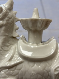 A Chinese Dehua blanc de Chine candlestick in the form a qilin, Kangxi