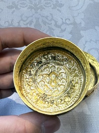 A fine Tibetan gilt-bronze box and cover with repouss&eacute; scroll decoration, 18th C.