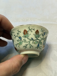 Two Dutch-decorated Chinese cups and saucers with parrots among flowering branches, 18th C.