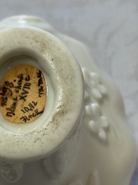A Chinese Dehua blanc de Chine 'Dragon, Carp, Crane and Deer' libation cup, Kangxi