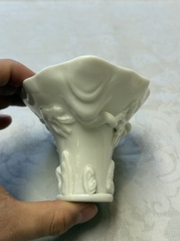 A Chinese Dehua blanc de Chine 'Dragon, Carp, Crane and Deer' libation cup, Kangxi