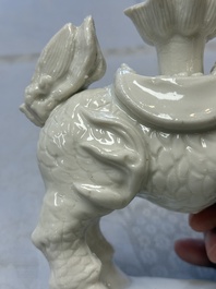 A Chinese Dehua blanc de Chine candlestick in the form a qilin, Kangxi