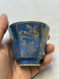 A pair of Chinese gilt-decorated powder-blue-ground 'Antiquities' cups and saucers, lingzhi mark, Kangxi