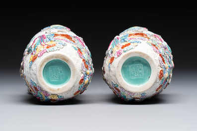 A pair of Chinese famille rose relief-moulded 'Immortals' vases, Qianlong mark, Republic