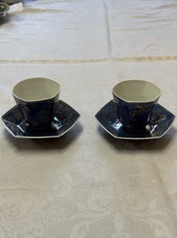 A pair of Chinese gilt-decorated powder-blue-ground 'Antiquities' cups and saucers, lingzhi mark, Kangxi