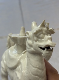 A Chinese Dehua blanc de Chine candlestick in the form a qilin, Kangxi