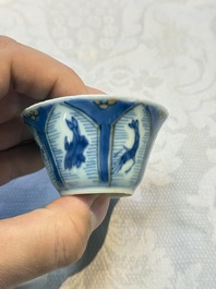 A Chinese European-decorated blue and white 'Fisherman' cup and saucer, Kangxi