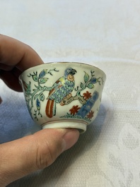Two Dutch-decorated Chinese cups and saucers with parrots among flowering branches, 18th C.
