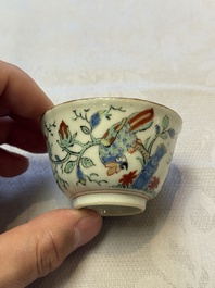 Two Dutch-decorated Chinese cups and saucers with parrots among flowering branches, 18th C.