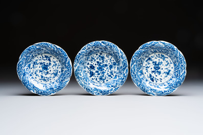 Eleven Chinese blue and white gadrooned 'Flowers and Peacocks' plates, Kangxi