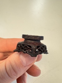 A Chinese carved white jade 'Geese' snuff bottle with a wooden stand, 18/19th C.