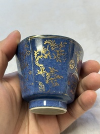 A pair of Chinese gilt-decorated powder-blue-ground 'Antiquities' cups and saucers, lingzhi mark, Kangxi