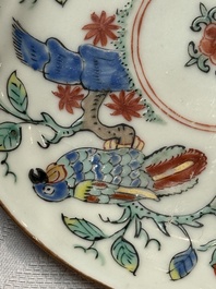 Two Dutch-decorated Chinese cups and saucers with parrots among flowering branches, 18th C.