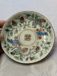 Two Dutch-decorated Chinese cups and saucers with parrots among flowering branches, 18th C.