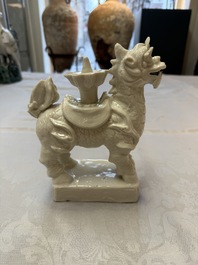 A Chinese Dehua blanc de Chine candlestick in the form a qilin, Kangxi
