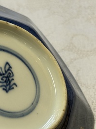 A pair of Chinese gilt-decorated powder-blue-ground 'Antiquities' cups and saucers, lingzhi mark, Kangxi