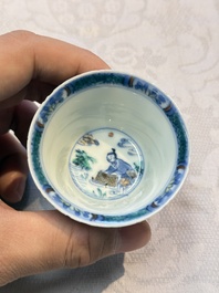 A Chinese European-decorated blue and white 'Fisherman' cup and saucer, Kangxi