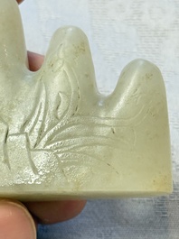 A Chinese white jade mountain-shaped brush rest with narcissus design, Dajie 大玠 mark, dated 1879