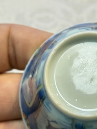 A Chinese European-decorated blue and white 'Fisherman' cup and saucer, Kangxi