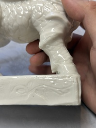 A Chinese Dehua blanc de Chine candlestick in the form a qilin, Kangxi