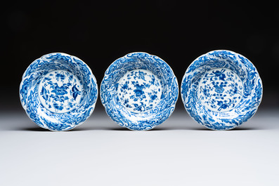 Eleven Chinese blue and white gadrooned 'Flowers and Peacocks' plates, Kangxi
