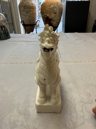 A Chinese Dehua blanc de Chine candlestick in the form a qilin, Kangxi