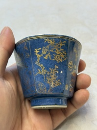 A pair of Chinese gilt-decorated powder-blue-ground 'Antiquities' cups and saucers, lingzhi mark, Kangxi