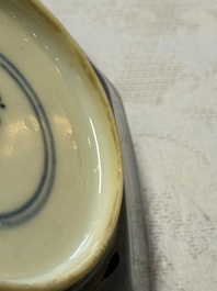 A pair of Chinese gilt-decorated powder-blue-ground 'Antiquities' cups and saucers, lingzhi mark, Kangxi