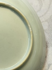 A Chinese European-decorated blue and white 'Fisherman' cup and saucer, Kangxi
