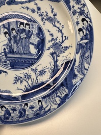 A fine Chinese blue and white 'Elegant Beauties' dish with raised central medallion, Kangxi