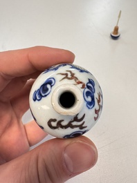 A Chinese blue, white and copper-red 'Dragon' snuff bottle, 19th C.