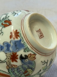 Two Dutch-decorated Chinese cups and saucers with parrots among flowering branches, 18th C.