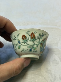 Two Dutch-decorated Chinese cups and saucers with parrots among flowering branches, 18th C.