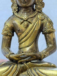 A Sino-Tibetan gilt-bronze figure of Buddha Amitayus, inscribed, Qianlong